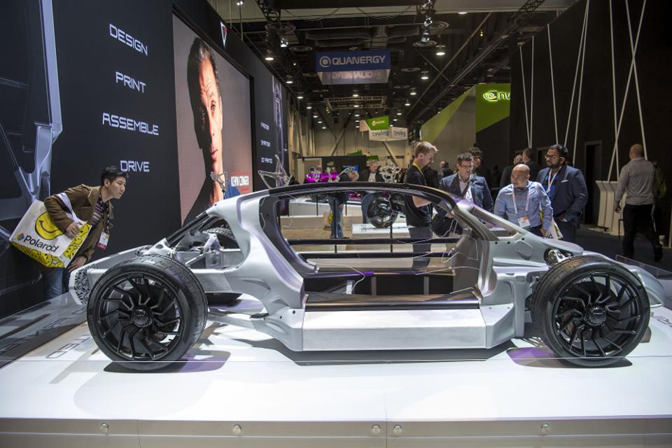 Attendees view vehicles manufactured by 3D printing design at the 2017 Consumer Electronics Show